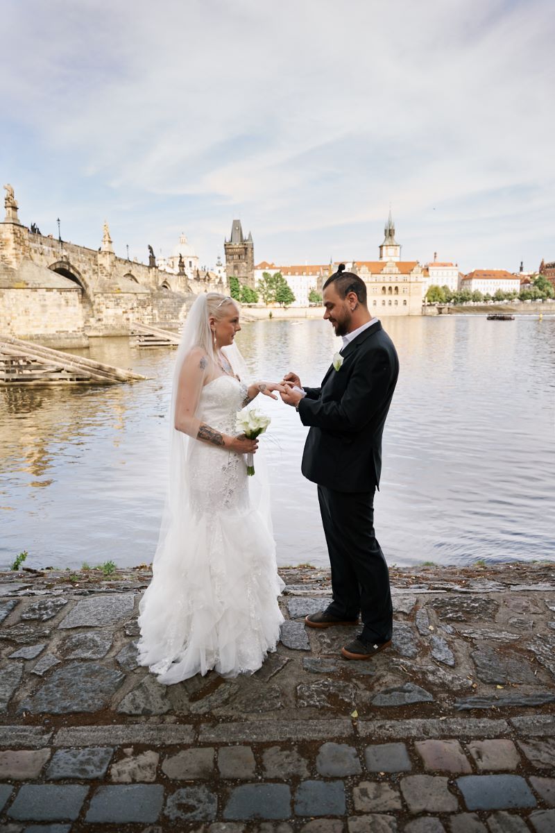 Lovers holding hands on Charles Bridge in Prague.